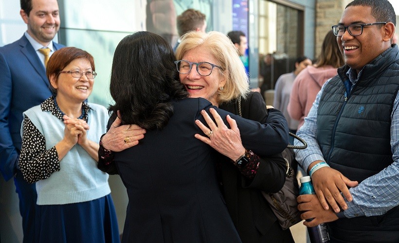 Student Life Vice President Kathy Byrnes hugs a colleague